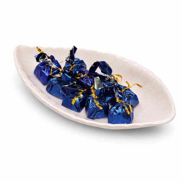 Ceramic dish with blue chocolates Ceramic dish with blue chocolates