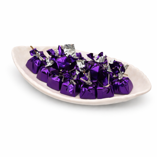 Ceramic dish with purple wrapped chocolates Ceramic dish with purple wrapped chocolates